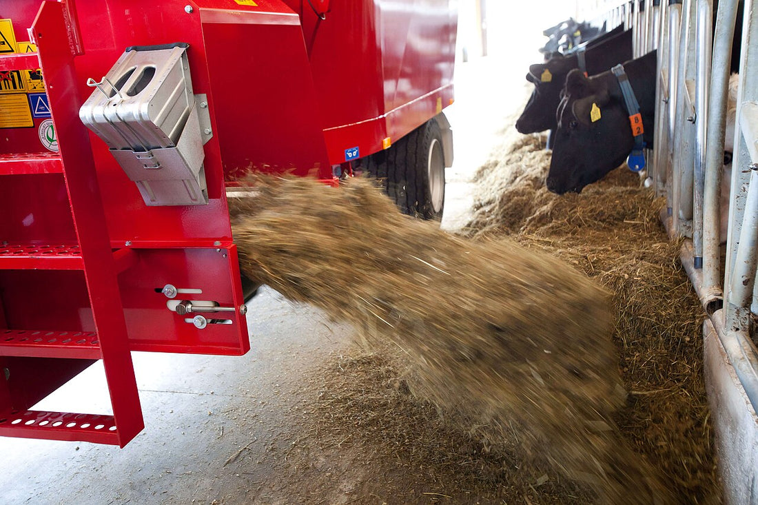 Trioliet Solomix vertical-auger TMR mixer wagon with two vertical augers visible at the loading edge — the type of mixer that gets fouled by net wrap left on bales at feed-out