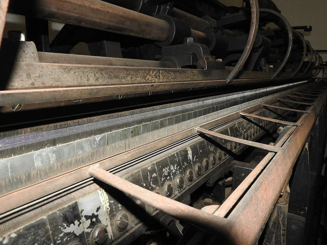 Warp knitting machine on a textile factory floor — the same machine class used to knit HDPE bale net wrap.